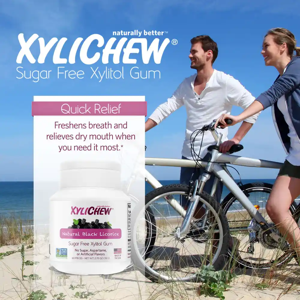 picture of man and woman with bicycles walking by the beach and a description with the benefits of chewing gum and a photo of xylitol Natural Black Licorice chewing gum in a bottle of 60 pcs chewing gums from the manufacturer Xylichew aspartam (aspartam free) | For website: healthychewinggum.com | Source: Xylichew