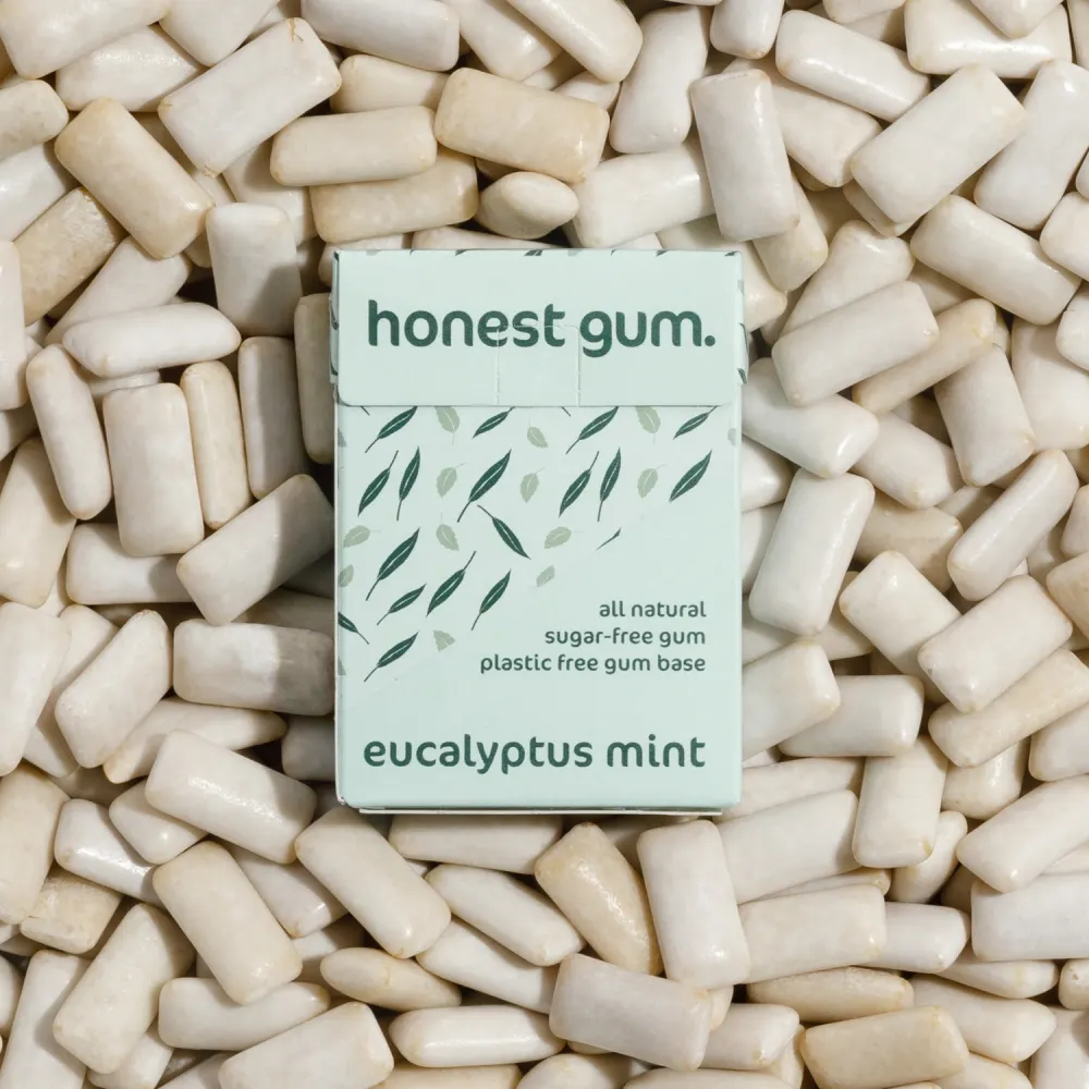 picture of Eucalyptus Mint All Nature Chewing Gum from honest gum in a flip box from the front on a background of chewing gum | plastic free, sugar free, sustainable and aspartam free | For website: healthychewinggum.com | Source: honest gum