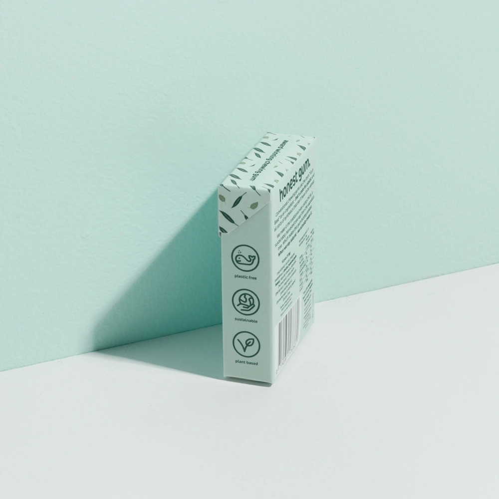 picture of Eucalyptus Mint All Nature Chewing Gum from honest gum in a flip box from the left back with 12 pcs on a green white background with a box shadow | Plastic free, sugar free, sustainable and aspartam free | For website: healthychewinggum.com | Source: honest gum