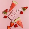 picture of Fruit All Nature Chewing Gum from honest gum in a flip box from the front on pink background with arranged eucalyptus, mint and chewing gum | plastic free, sugar free, sustainable and aspartam free | For website: healthychewinggum.com | Source: honest gum