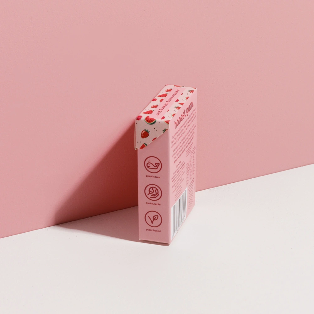 picture of Fruit All Nature Chewing Gum from honest gum in a flip box from the left back with 12 pcs on a pink white background with a box shadow | Plastic free, sugar free, sustainable and aspartam free | For website: healthychewinggum.com | Source: honest gum
