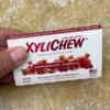 Detail of Pomegranate Raspberry chewing gum from the front - Xylichew gum with rubber base without plastic materials (no plastic) on yellow background | For the web: healthychewinggum.com | Author: Jiri Samuel