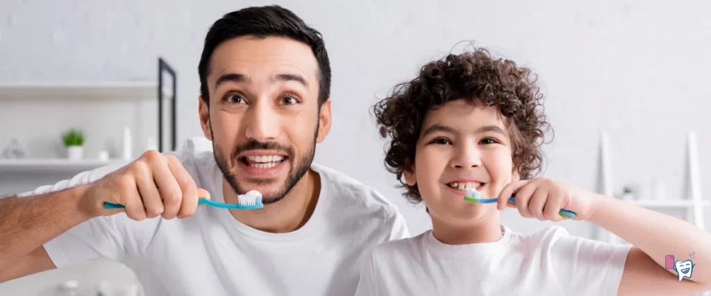 A smiling arabian man and his son are brushing teeth together | For article: The Best Way to Brush Teeth | For website: healthychewinggum.com | Source: shutterstock